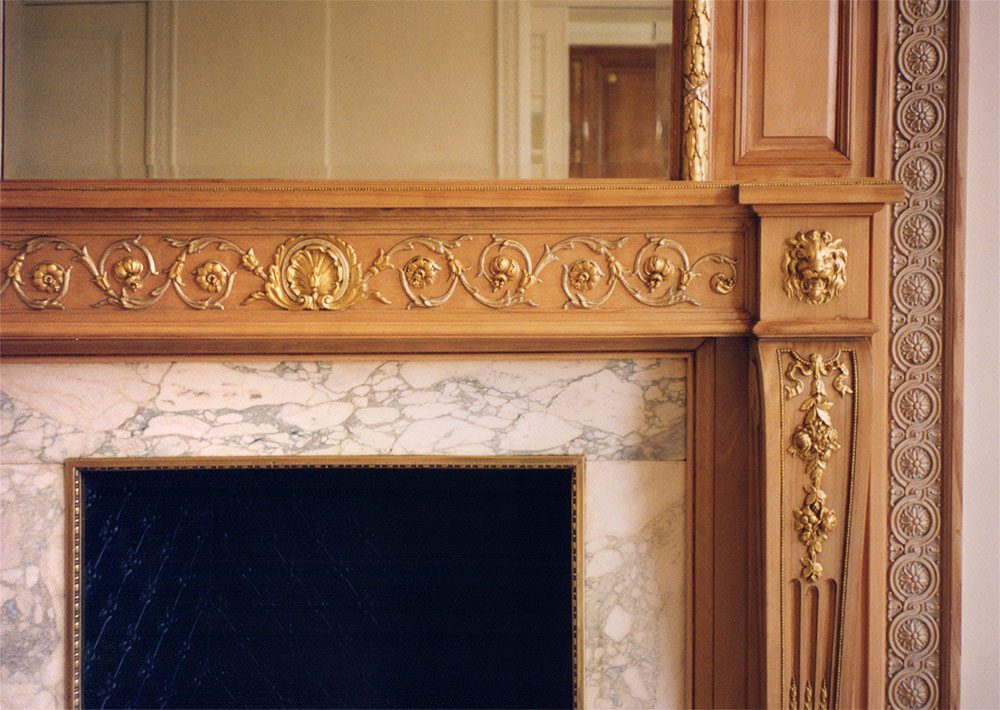Classic Adams wooden fireplace with gilded details