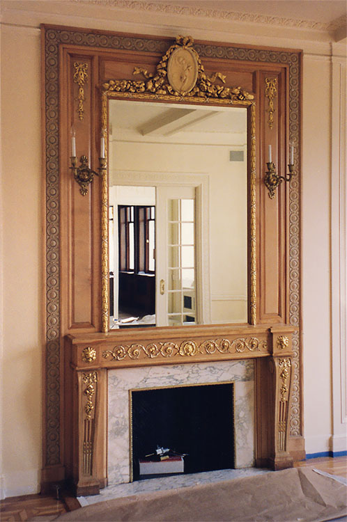 Classic Adams wooden fireplace with gilded details