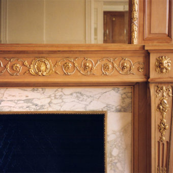 Classic Adams wooden fireplace with gilded details