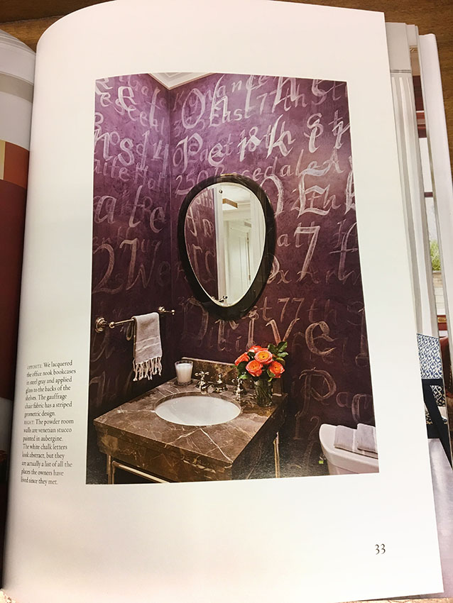 Antiqued iridescent calligraphy on aubergine Venetian plaster walls